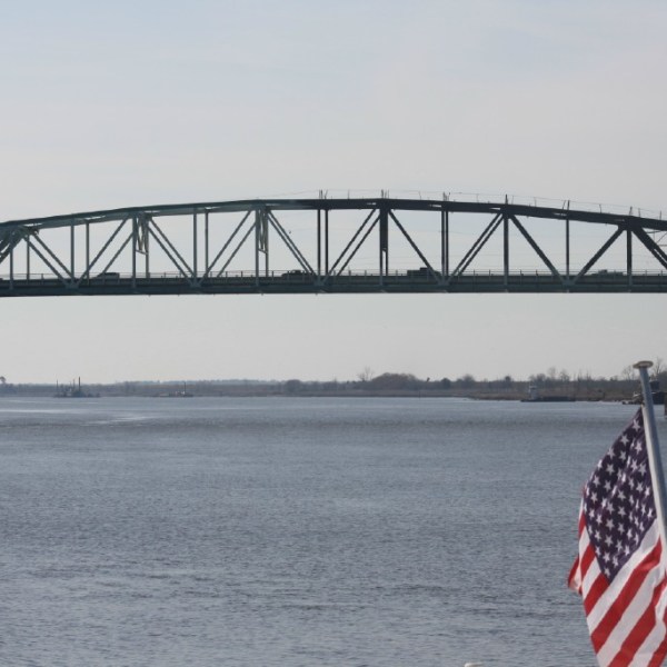 a train crossing a bridge over a body of water