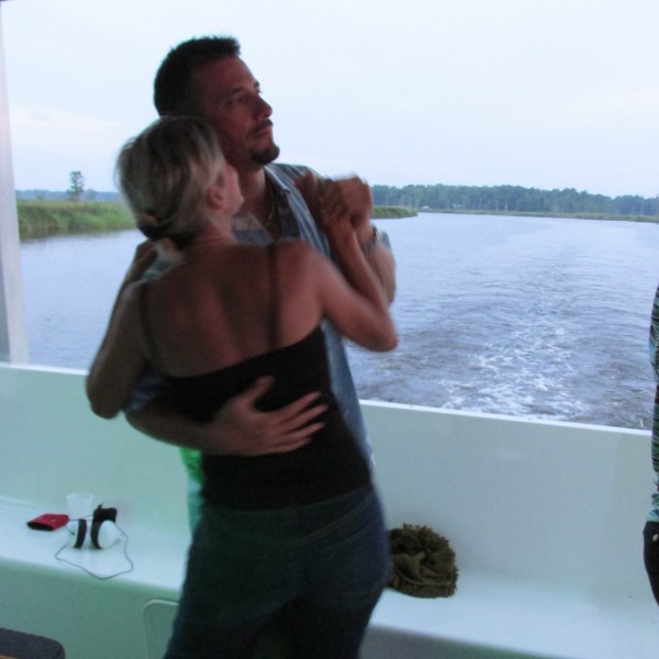 a man standing next to a body of water