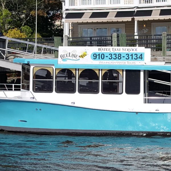 a blue and white boat parked on the side of a building