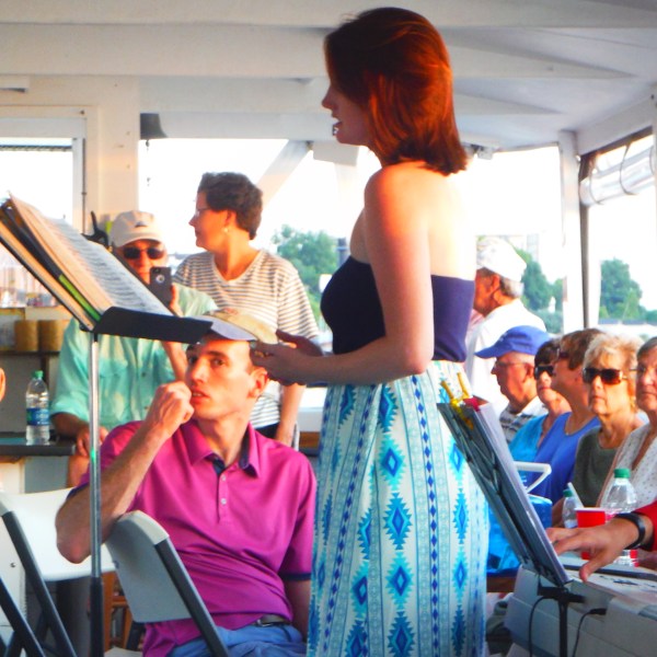 a woman holding a birthday cake