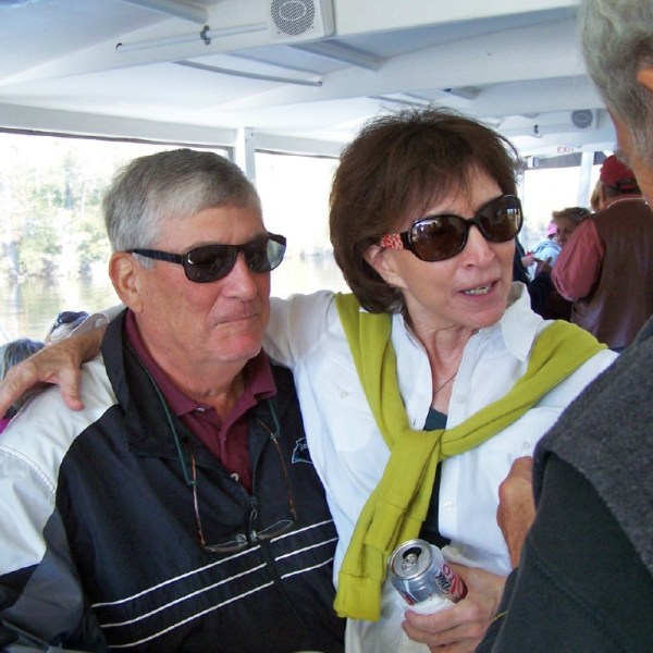 a group of people looking at a person who is wearing sunglasses