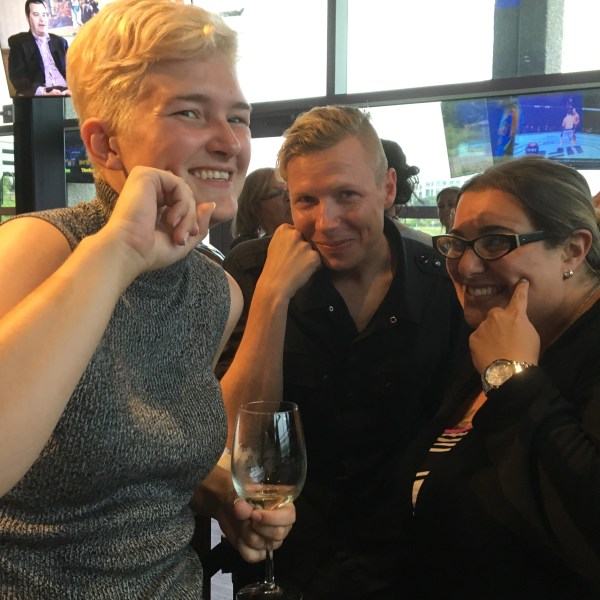 a group of people holding wine glasses