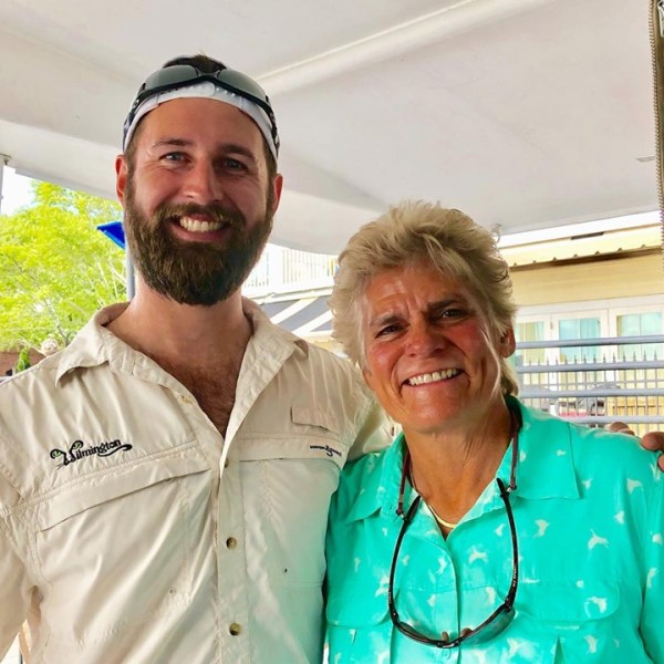 a man standing in front of a window posing for the camera