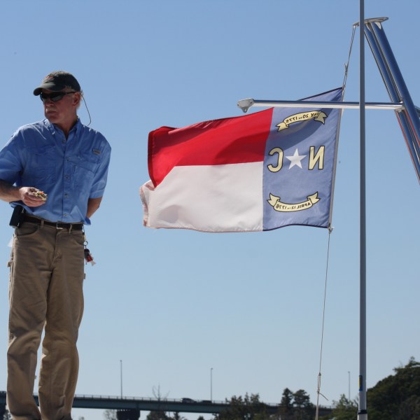 a man standing next to a boat