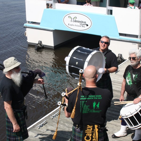 a person standing next to a boat