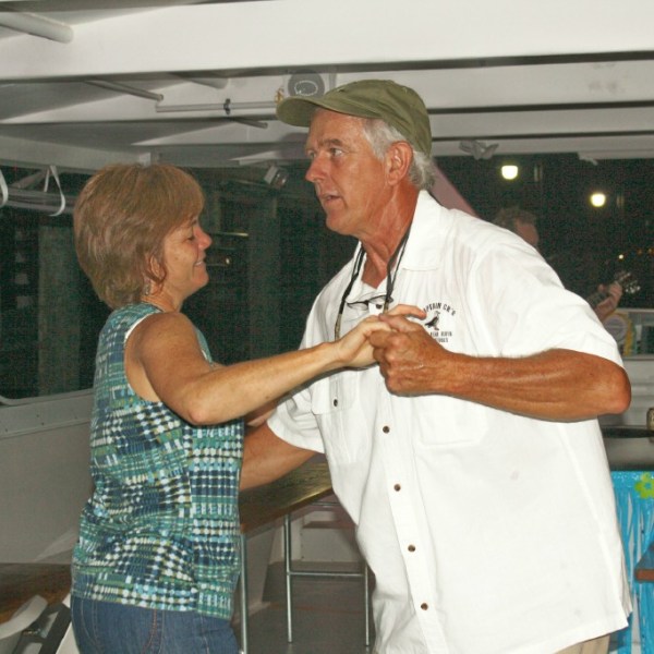a man and a woman standing in a kitchen
