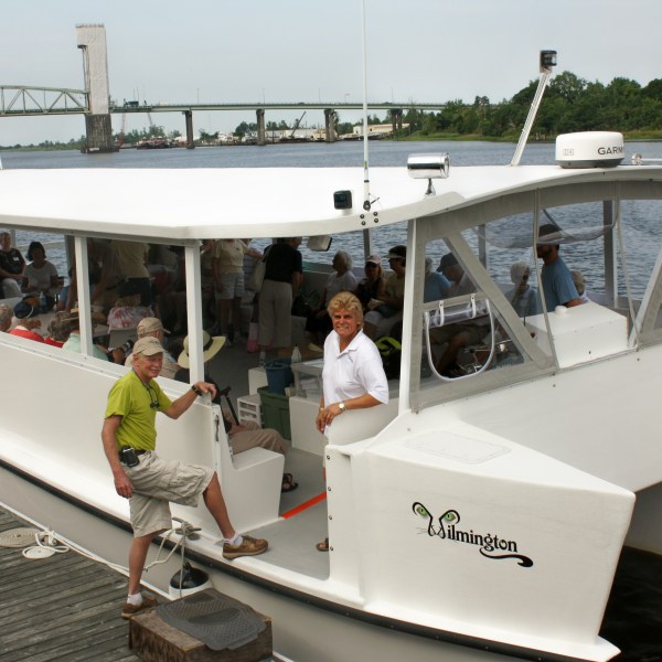 a group of people standing on a boat