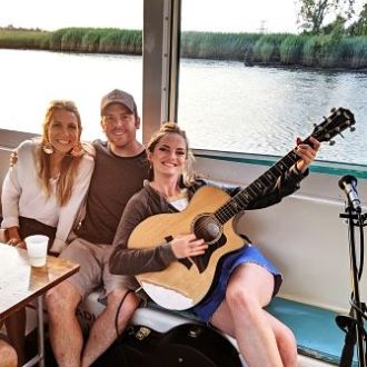 a group of people sitting in front of a body of water