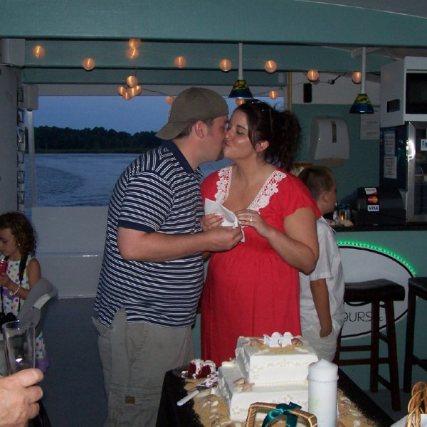 a couple of people that are eating some cake