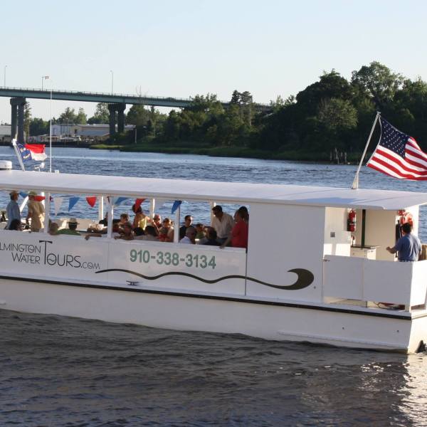 a group of people on a boat in a large body of water