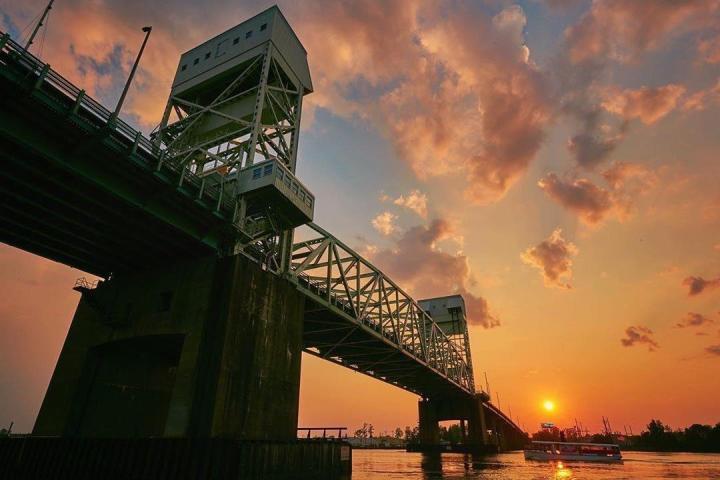 a train crossing a bridge over a body of water