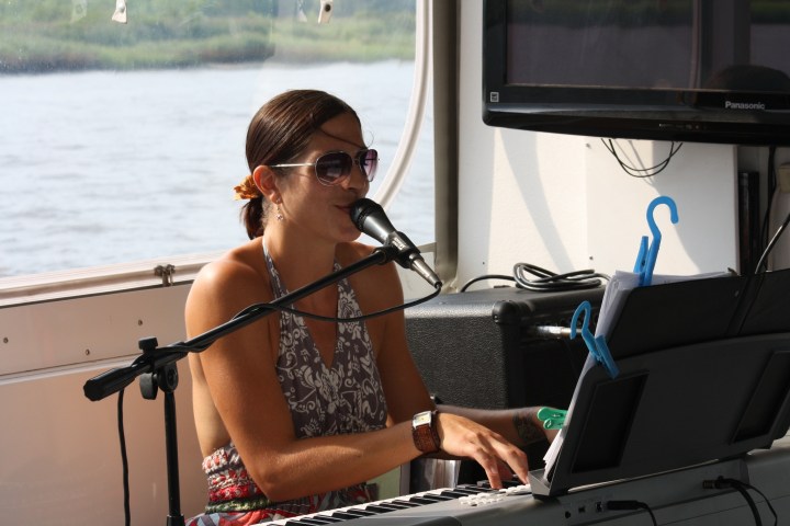 a woman sitting on a boat in the water